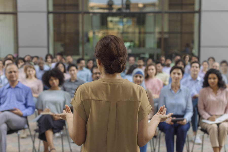 A leader addressing a large professional audience